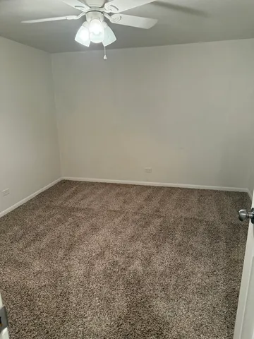 a view of a room with a fan and a fan