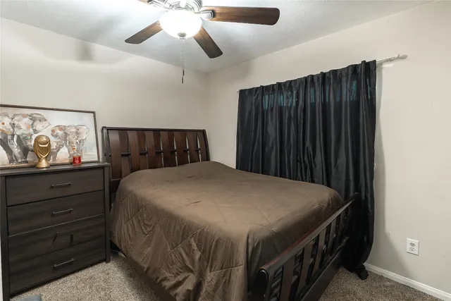 a bedroom with a bed and cabinet