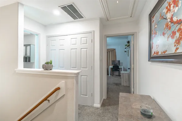 a view of a hallway view with wooden floor and staircase