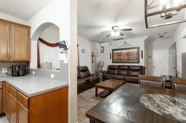 a living room with furniture a fireplace and a chandelier