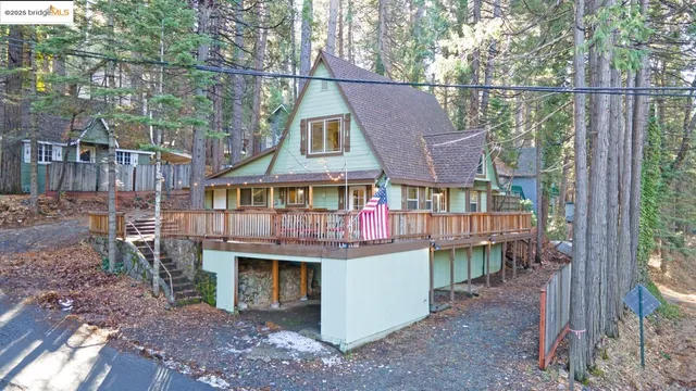 a view of a house with a yard from a deck
