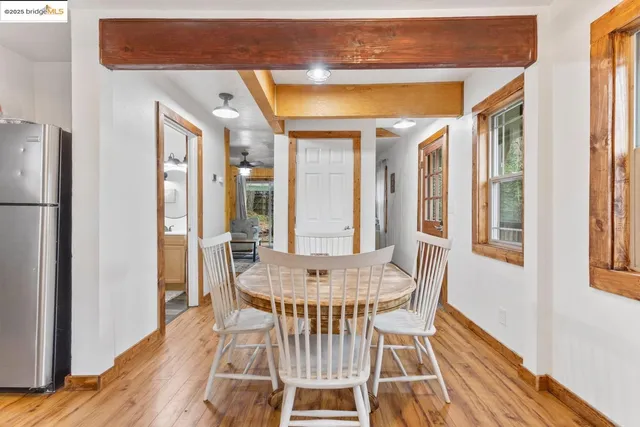 a dining room with furniture and wooden floor