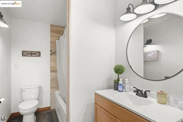 a bathroom with a toilet sink and mirror