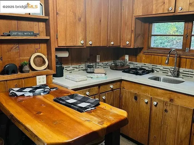 a kitchen with a stove a sink and a microwave
