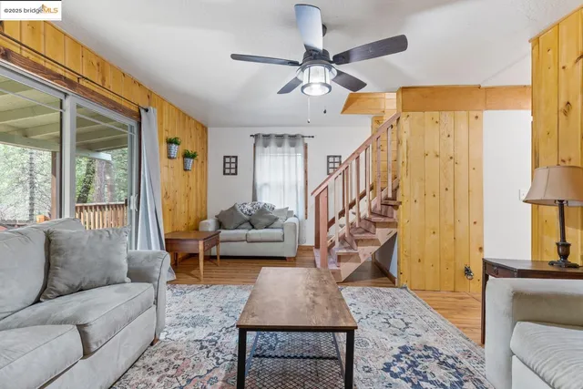 a living room with patio furniture and a wooden floor
