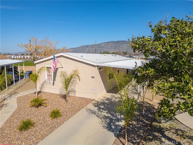 a backyard of a house with barbeque oven table and chairs