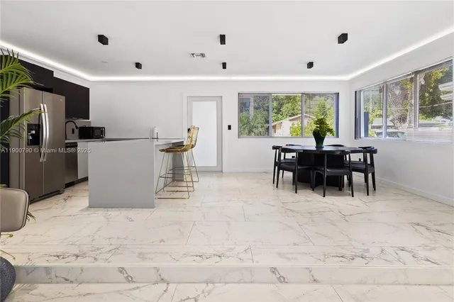 a view of a dining room with furniture window and outside view