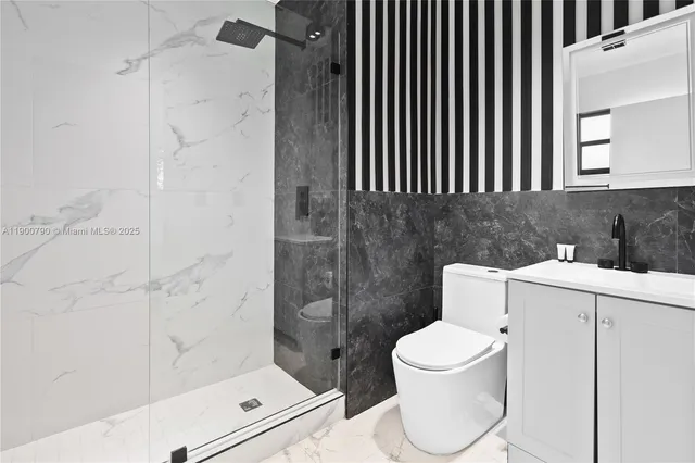 a bathroom with a toilet and a shower