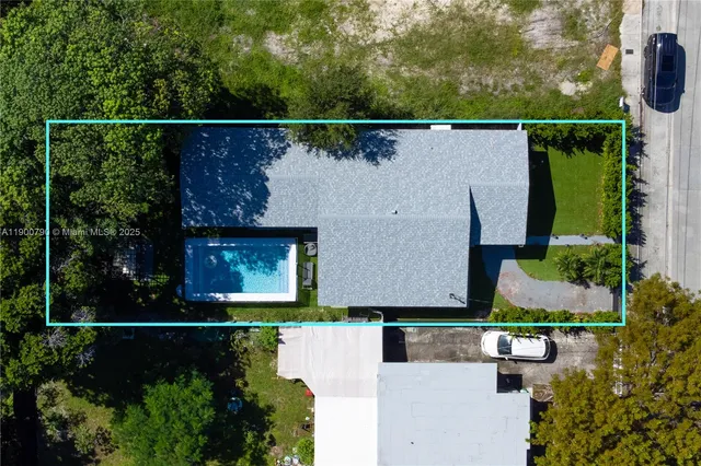 an aerial view of house with a yard