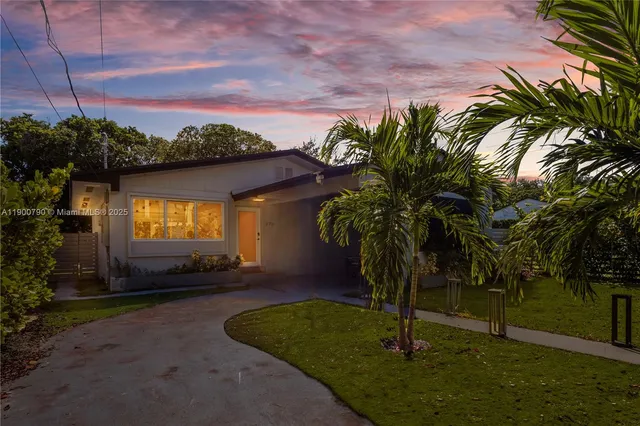 a house with swimming pool in front of it