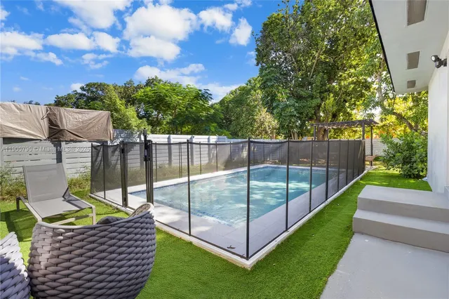 a view of a park with iron fence
