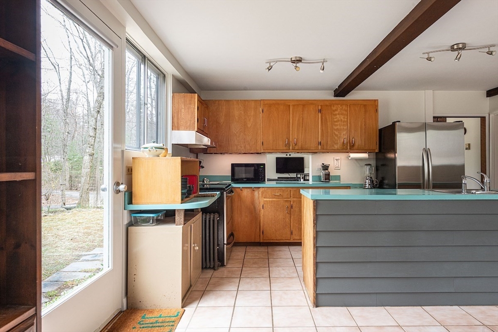 31 Turning Mill Road Lexington, MA 02420 - Photo 10 of 32 a kitchen with a sink cabinets and window