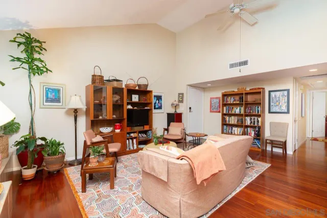 a living room with furniture and a book shelf