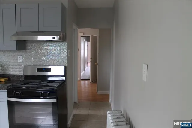 a kitchen with cabinets and a stove top oven
