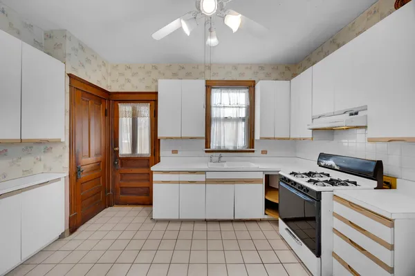 a kitchen with a stove a refrigerator and a sink