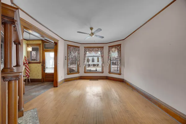 a view of a hallway with wooden floor and staircase