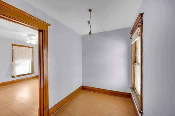 a view of a room with wooden floor and window