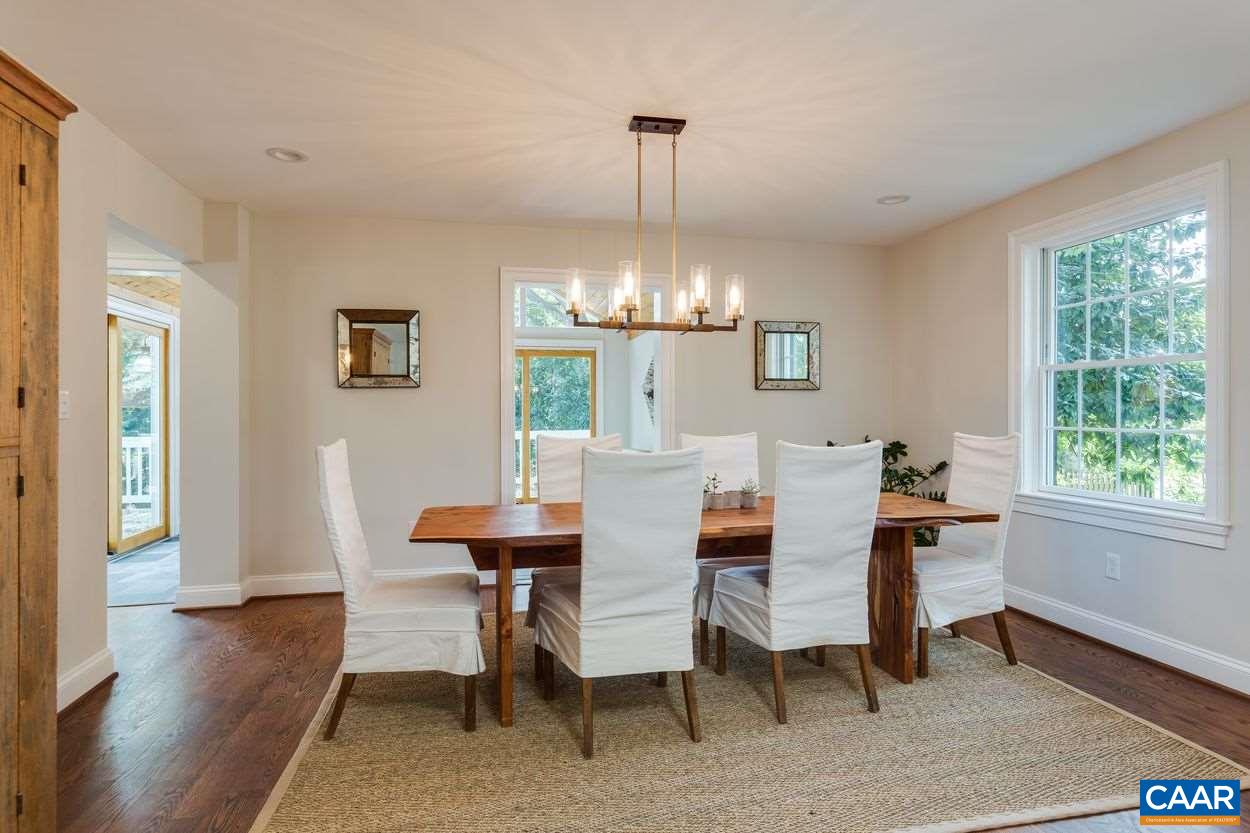 316 Kent Road Charlottesville, VA 22903 - Photo 20 of 47 a dining room with furniture a chandelier and wooden floor