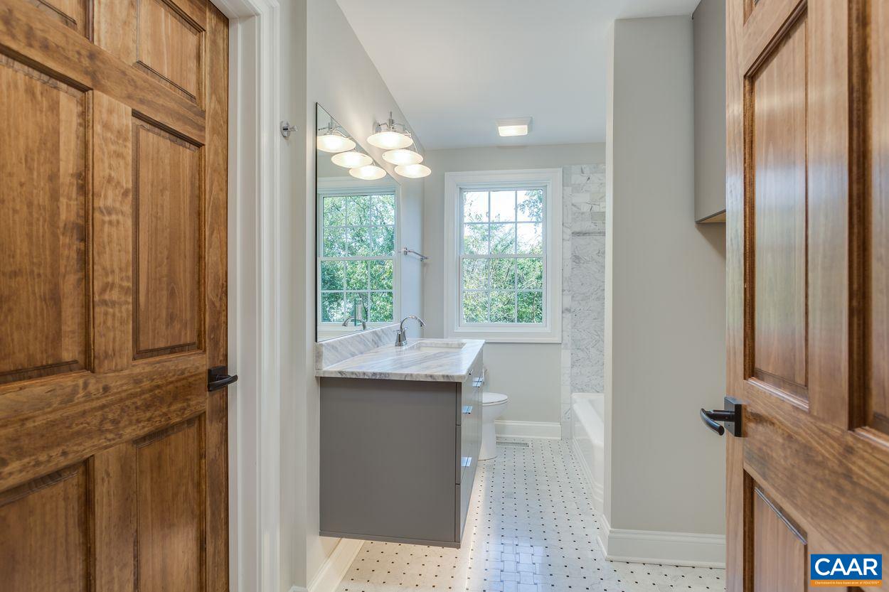 316 Kent Road Charlottesville, VA 22903 - Photo 30 of 47 a bathroom with a granite countertop sink and a mirror