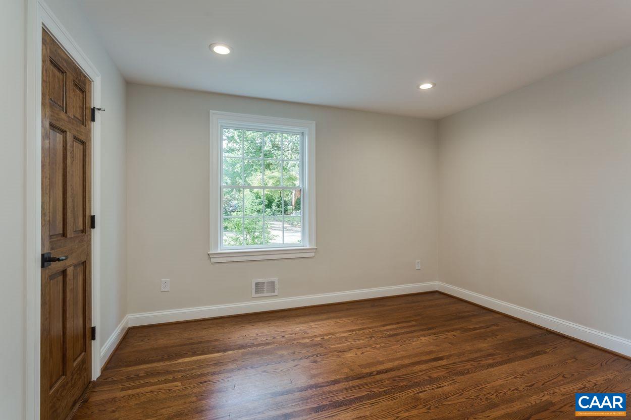 316 Kent Road Charlottesville, VA 22903 - Photo 31 of 47 an empty room with wooden floor and a window
