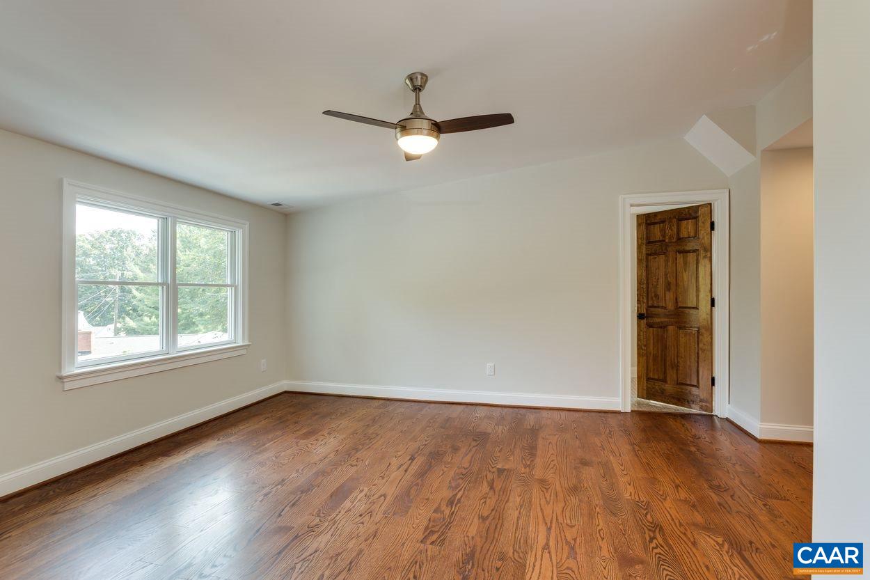 316 Kent Road Charlottesville, VA 22903 - Photo 36 of 47 an empty room with wooden floor ceiling fan and windows