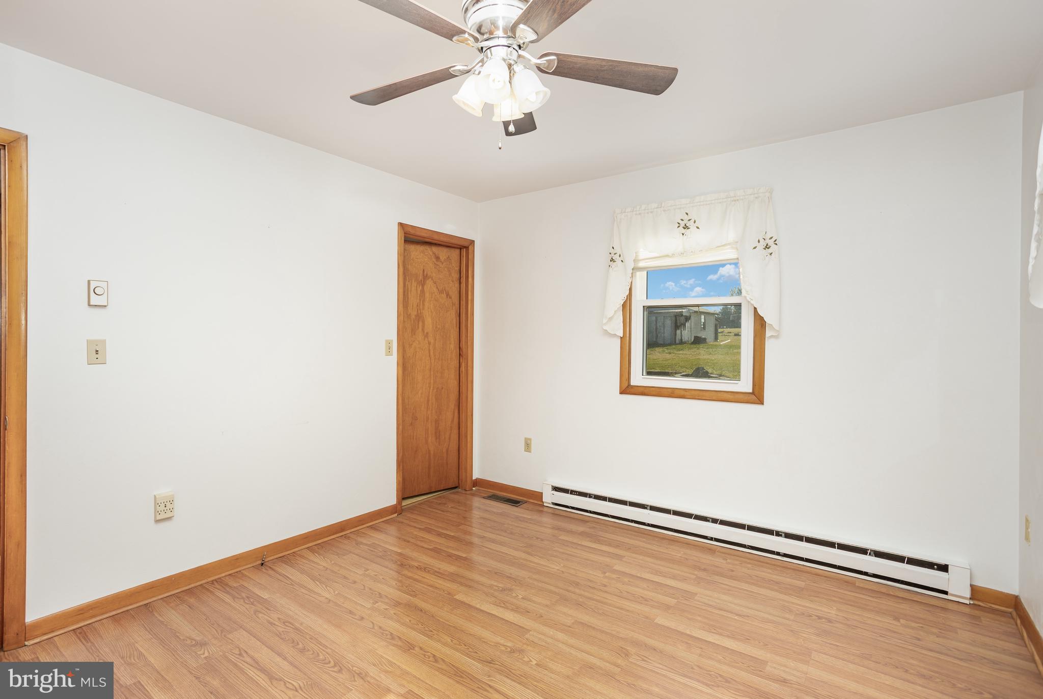 1487 Kbs Road Spring Grove, PA 17362 - Photo 14 of 35 an empty room with wooden floor chandelier fan and windows
