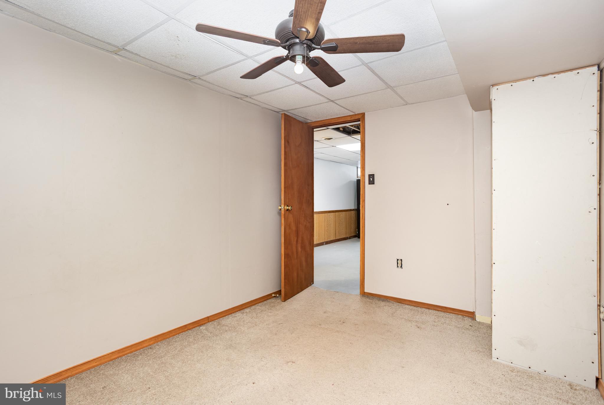 1487 Kbs Road Spring Grove, PA 17362 - Photo 25 of 35 an empty room with a ceiling fan and carpet