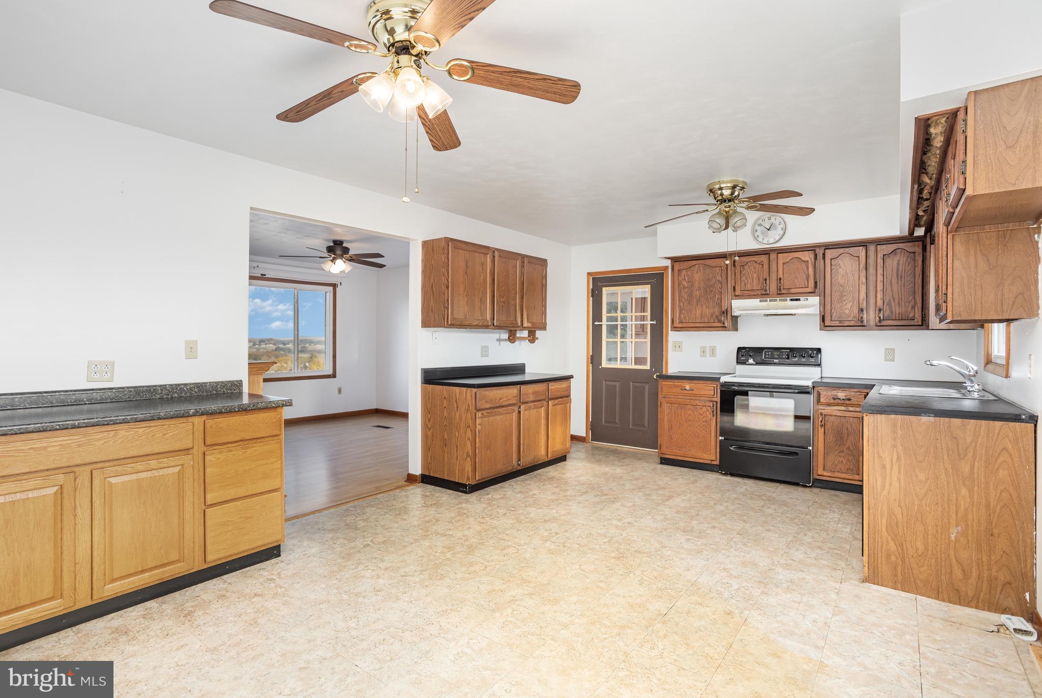 1487 Kbs Road Spring Grove, PA 17362 - Photo 8 of 35 a kitchen with stainless steel appliances kitchen island granite countertop a stove a sink and a refrigerator