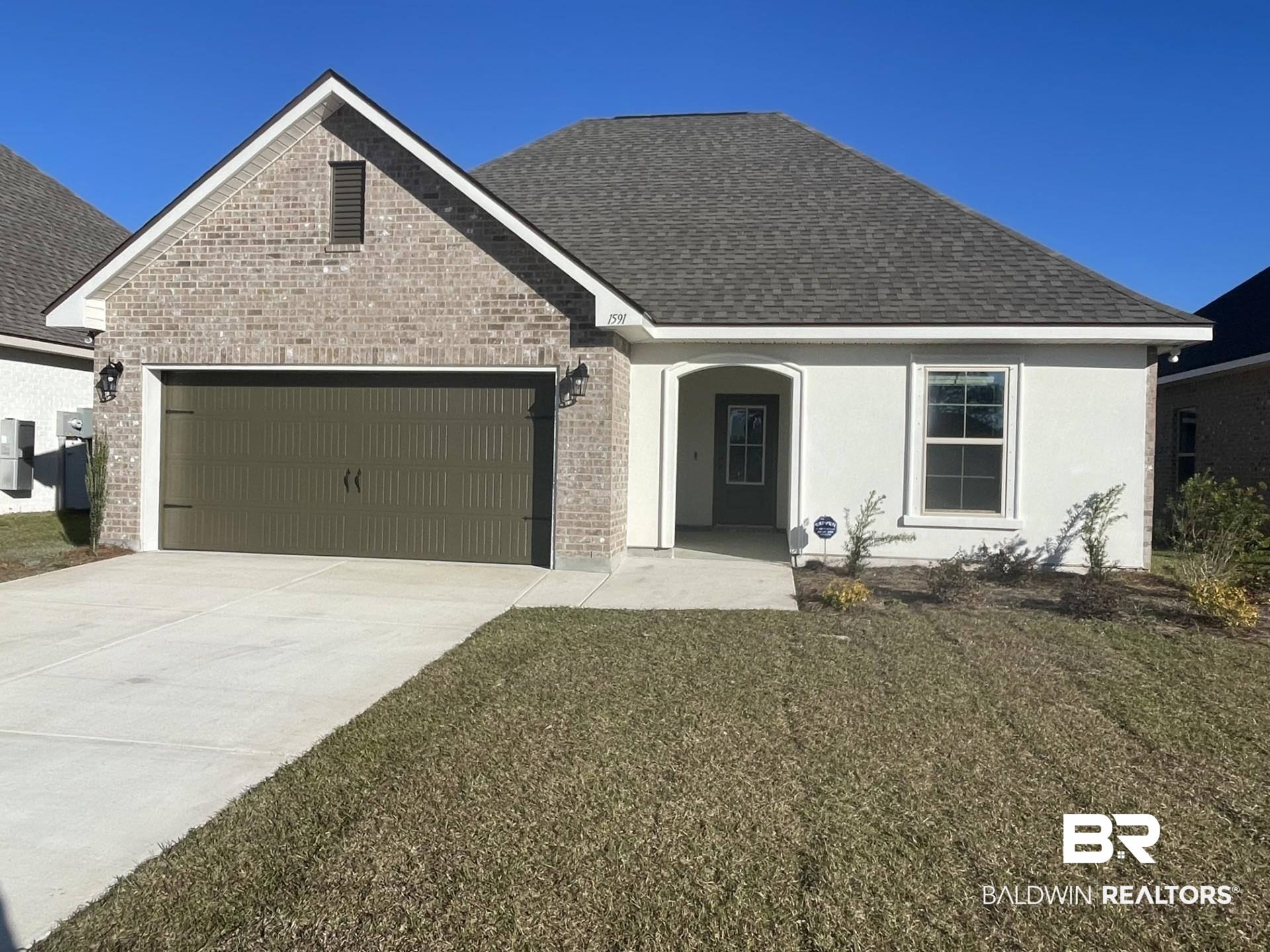 1591 Fenton Circle Foley, AL 36535 - Photo 1 of 3 View of front of home featuring a garage and a front lawn