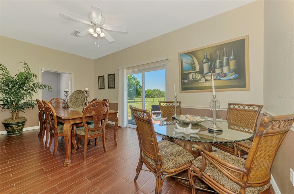 2700 Verna Bethany Road Myakka City, FL 34251 - Photo 21 of 61 a view of a dining room with furniture window and wooden floor