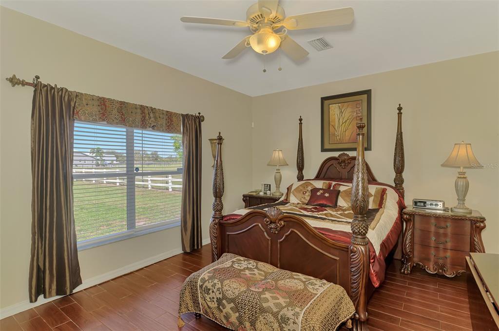 2700 Verna Bethany Road Myakka City, FL 34251 - Photo 25 of 61 a bedroom with a bed and wooden floor