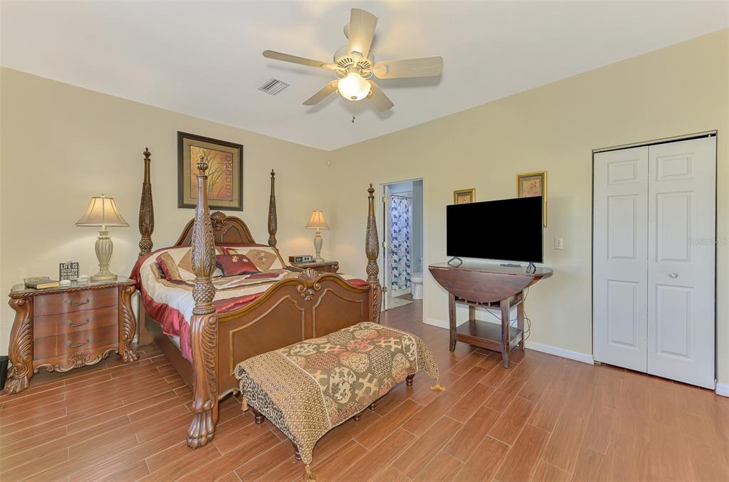 2700 Verna Bethany Road Myakka City, FL 34251 - Photo 27 of 61 a living room with a bed furniture and a flat screen tv
