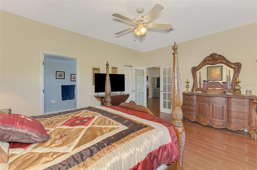 2700 Verna Bethany Road Myakka City, FL 34251 - Photo 28 of 61 a bedroom with a bed and a flat screen tv