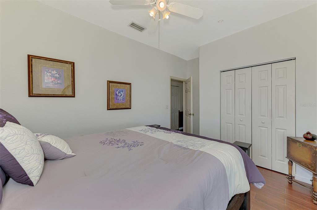 2700 Verna Bethany Road Myakka City, FL 34251 - Photo 32 of 61 a bedroom with a bed and a chandelier