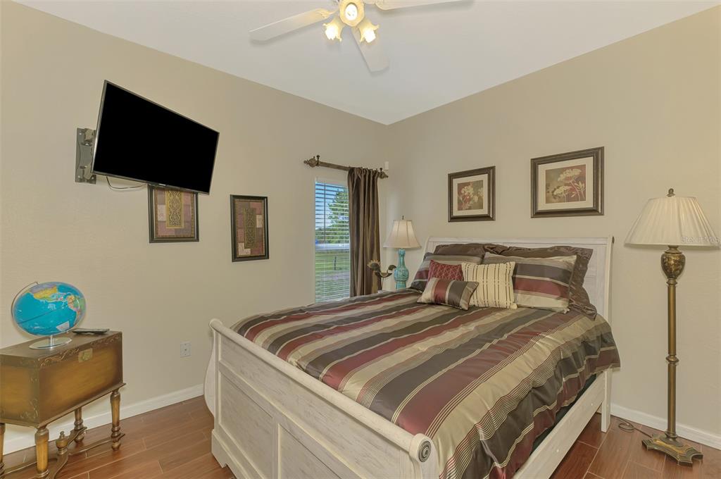 2700 Verna Bethany Road Myakka City, FL 34251 - Photo 34 of 61 a bedroom with a bed and a flat screen tv