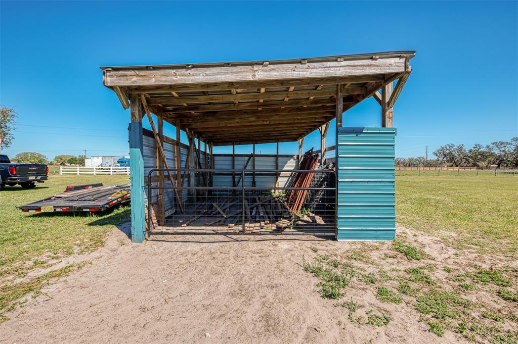2700 Verna Bethany Road Myakka City, FL 34251 - Photo 44 of 61 a view of a wooden deck with a table and chairs a barbeque with wooden fence