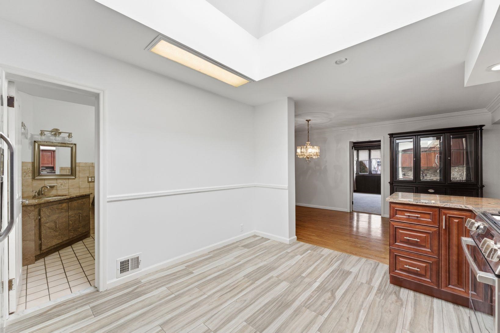 229 Centre Avenue Secaucus, NJ 07094 - Photo 12 of 40 a view of a hallway with wooden floor and a living room