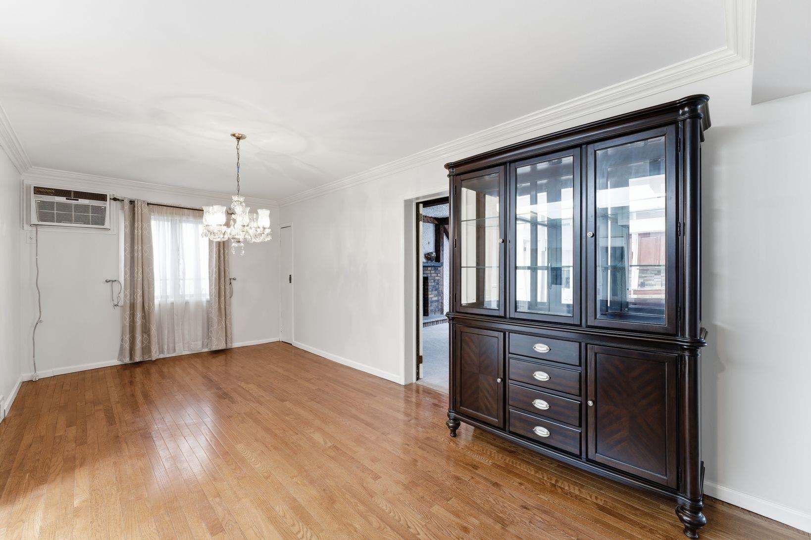 229 Centre Avenue Secaucus, NJ 07094 - Photo 14 of 40 a view of an empty room and window with wooden floor
