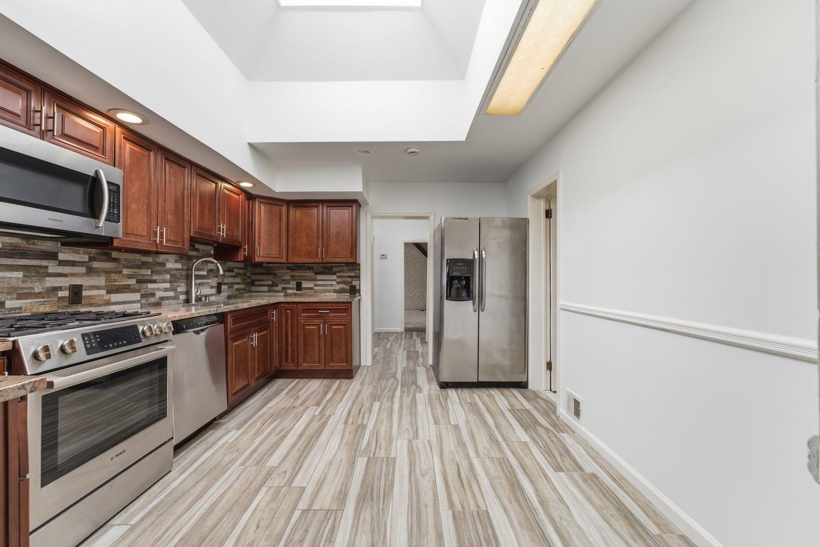 229 Centre Avenue Secaucus, NJ 07094 - Photo 8 of 40 a kitchen with stainless steel appliances a refrigerator sink and microwave