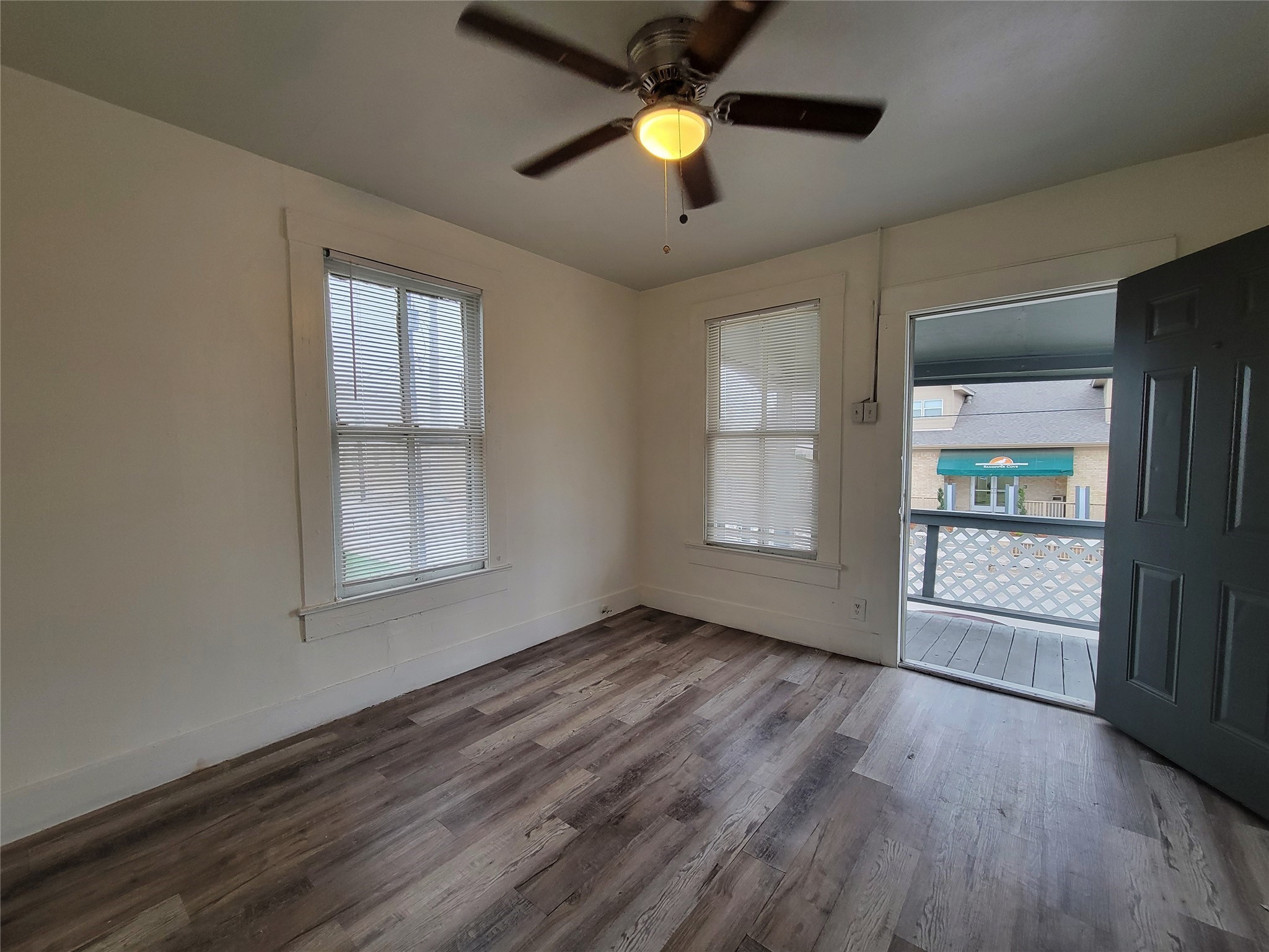 3913 Winnie Street, Unit UP Galveston, TX 77550 - Photo 3 of 9 wooden floor in an empty room with a window
