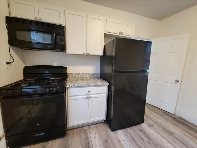 a kitchen with a stove microwave and refrigerator