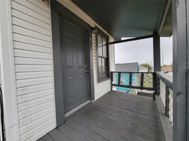 a porch with a table and chairs