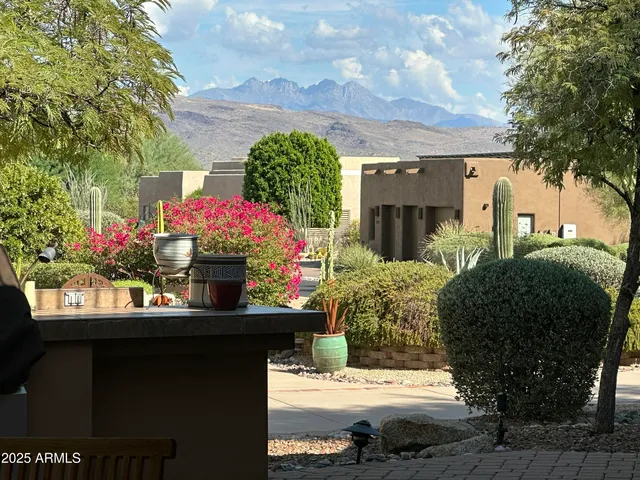 a front view of a house with a yard and potted plants