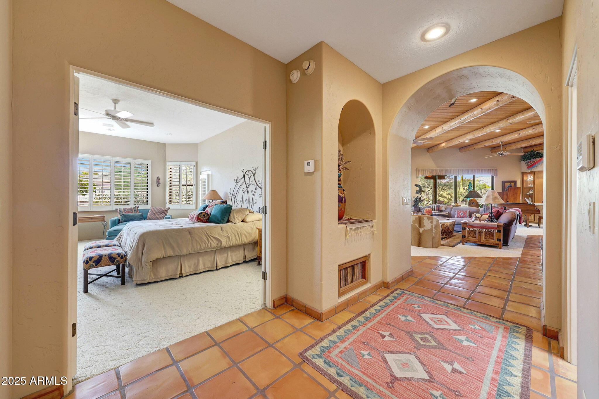 18610 East Gemmill Drive Rio Verde, AZ 85263 - Photo 29 of 65 a bedroom with a large bed couch and a view of living room