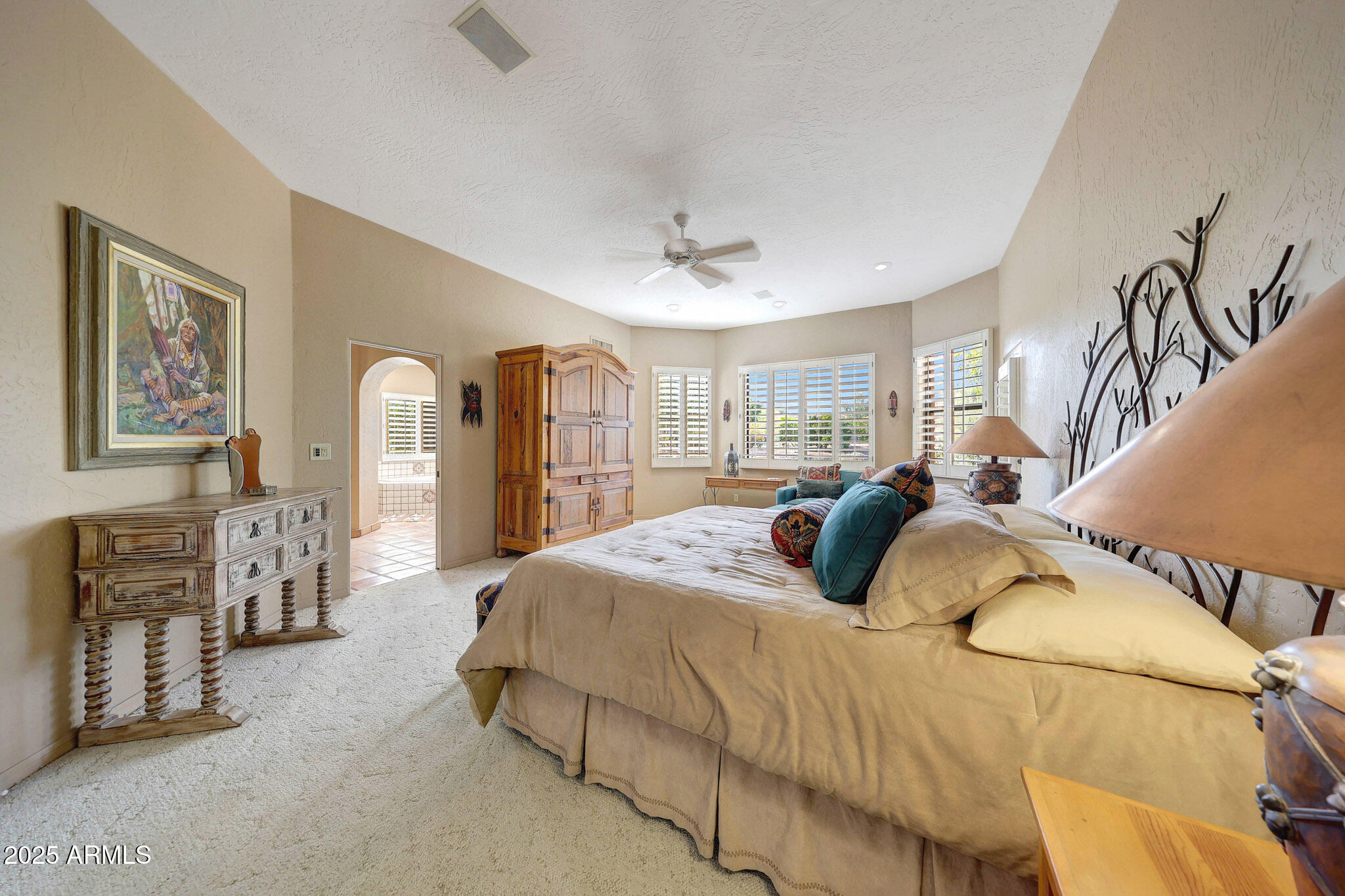 18610 East Gemmill Drive Rio Verde, AZ 85263 - Photo 40 of 53 a bedroom with a large bed and a chandelier