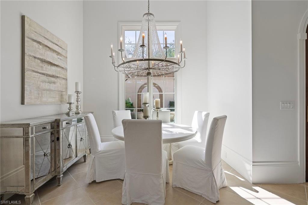 15655 Villoresi Way Naples, FL 34110 - Photo 19 of 47 a view of a dining room with furniture