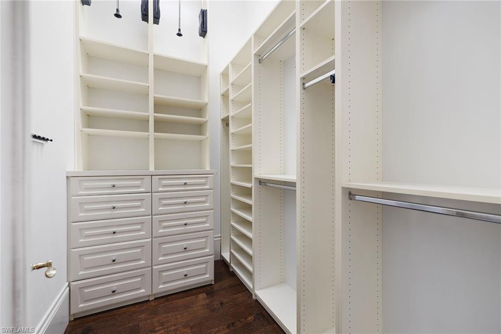 15655 Villoresi Way Naples, FL 34110 - Photo 25 of 47 a view of walk in closet with empty racks