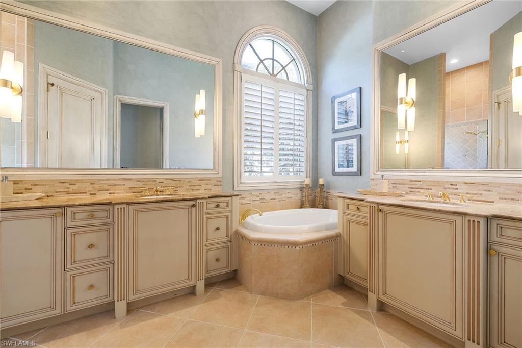 15655 Villoresi Way Naples, FL 34110 - Photo 26 of 47 a spacious bathroom with a double vanity sink mirror and bathtub