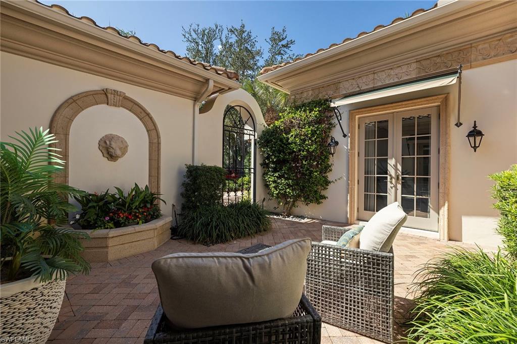 15655 Villoresi Way Naples, FL 34110 - Photo 34 of 47 a view of a house with outdoor seating and plants
