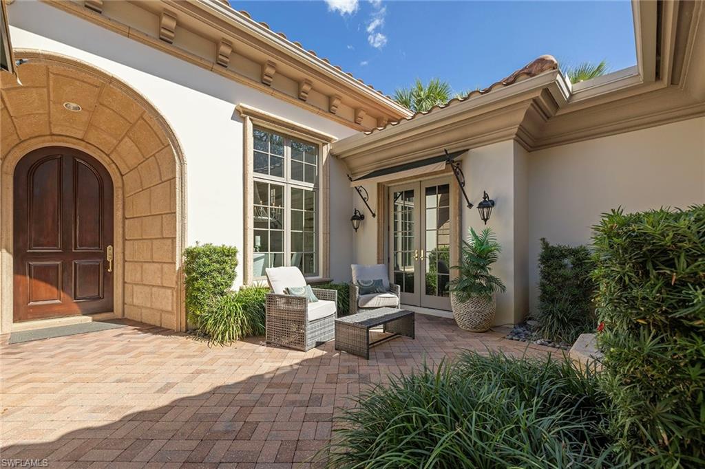 15655 Villoresi Way Naples, FL 34110 - Photo 36 of 47 a building outdoor space with patio furniture and potted plants